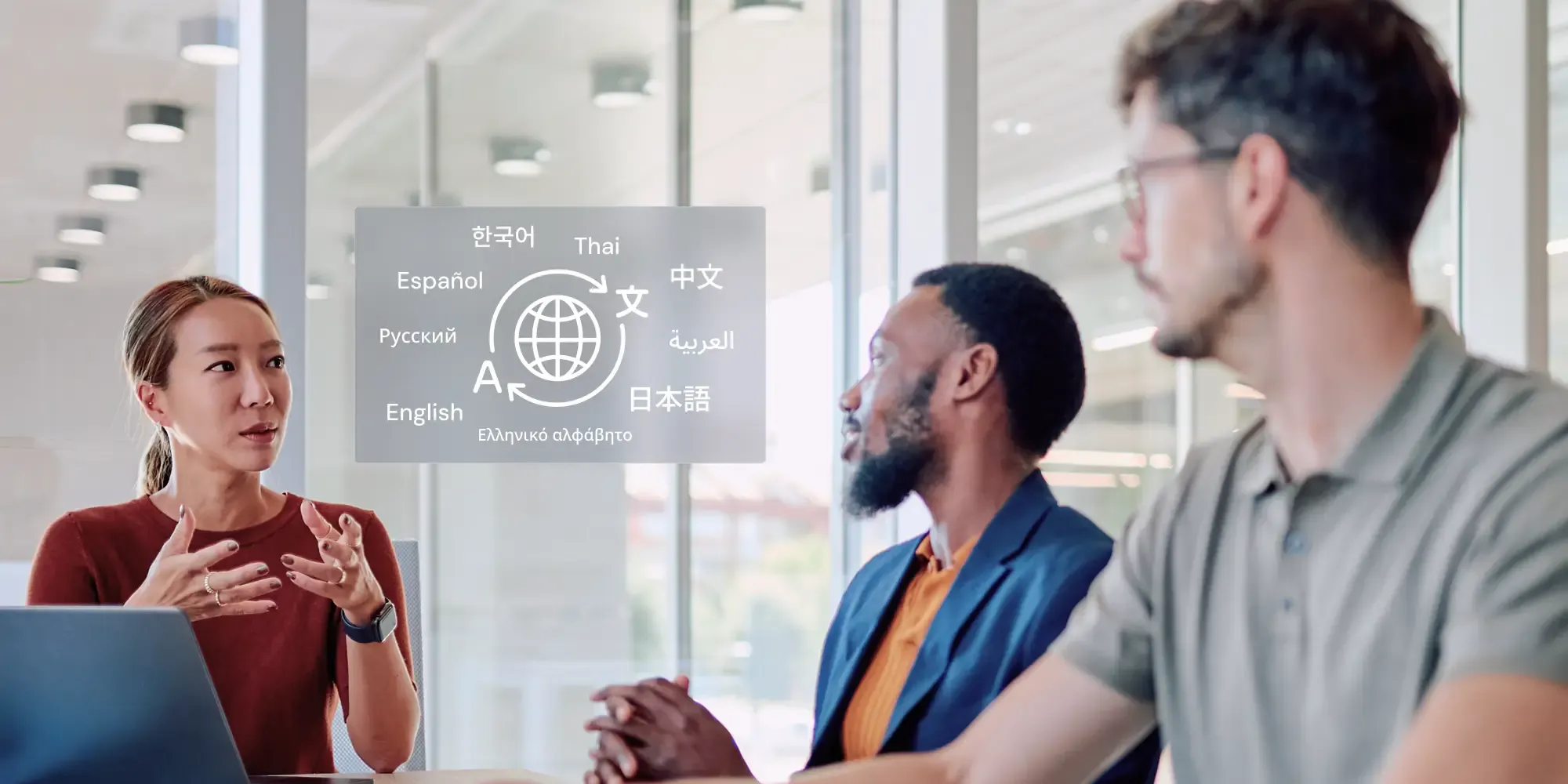 Three professionals converse in a glass-walled office meeting. A digital graphic overlays the scene between them, featuring a globe translation icon surrounded by various languages in their native scripts.