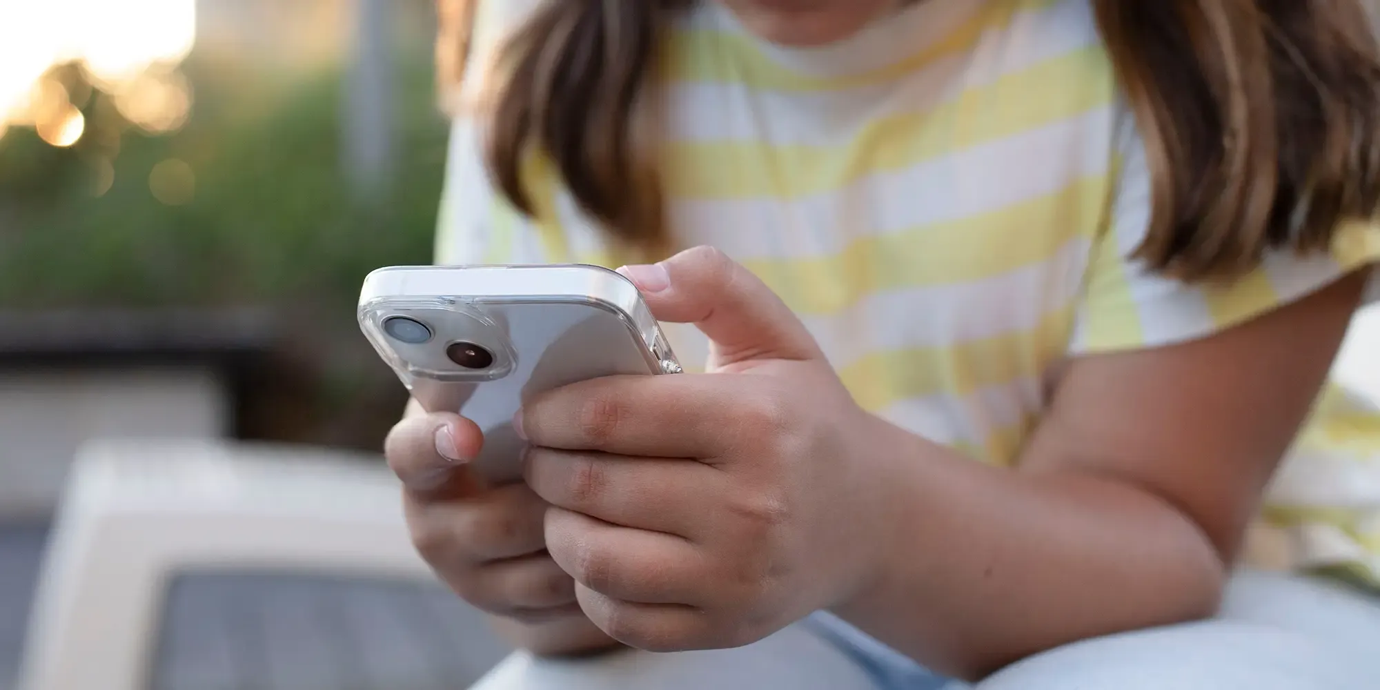 A young student using a mobile device safely, representing key themes from the 2026 Safer Internet India Summit on digital trust and online security.