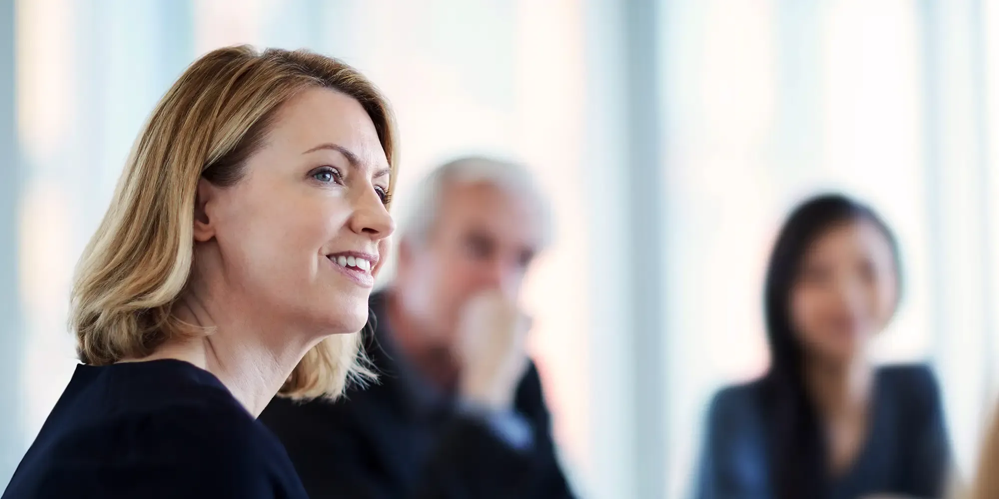 A sales agent with a headset pointing to a schedule chart, demonstrating organized planning to reduce stress and drive growth with team well-being.