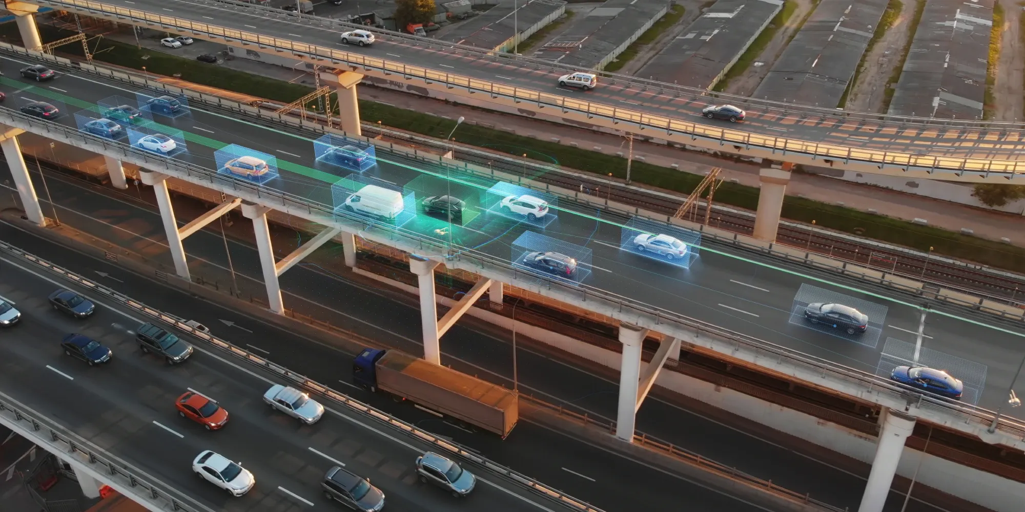 Aerial view of autonomous vehicles driving on a highway with digital 3D bounding boxes highlighting sensor detection and smart traffic management.