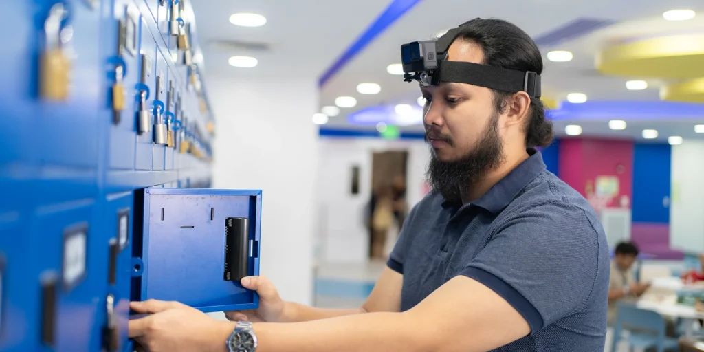 An operator wearing a head-mounted camera collects egocentric video by opening a locker, demonstrating techniques for mastering complex robotics data operations.