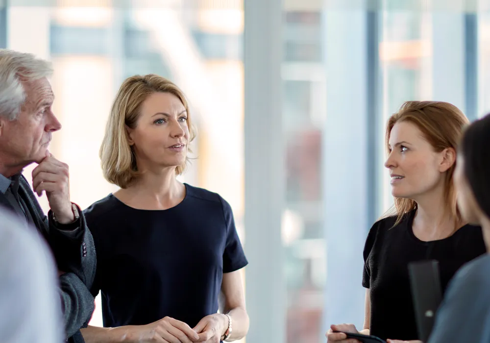 Strategic leadership team collaborating on corporate business goals during an executive board meeting in a professional office setting.